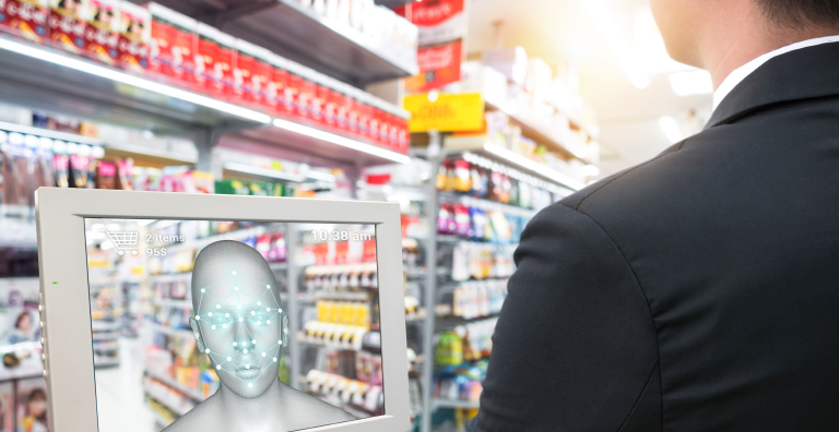 A person using facial recognition technology at a grocery store checkout.