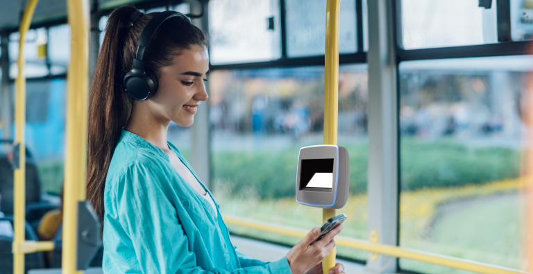 person riding bus looking at phone