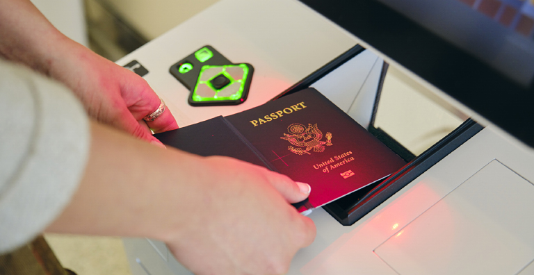 person scanning passport at kiosk