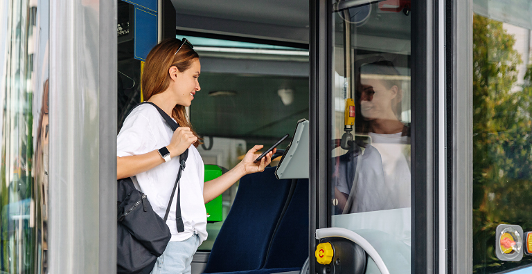 person paying bus fare with phone