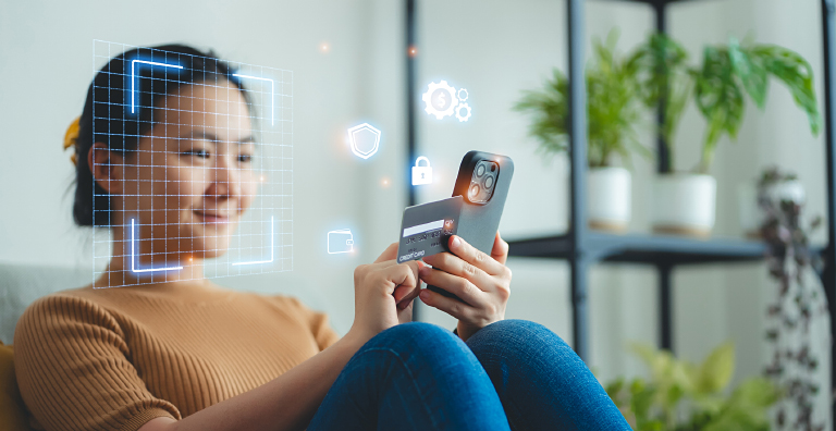 person holding phone and credit card