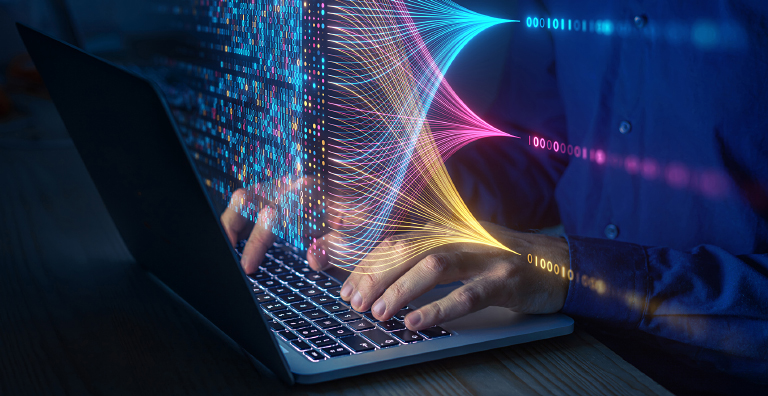 Person typing on laptop with flowing multicolored data streams representing agile cryptographic transformation and adaptive cybersecurity in a digital environment.