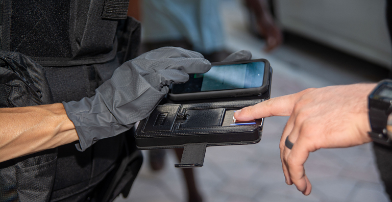 person being fingerprinted using mobile scanner