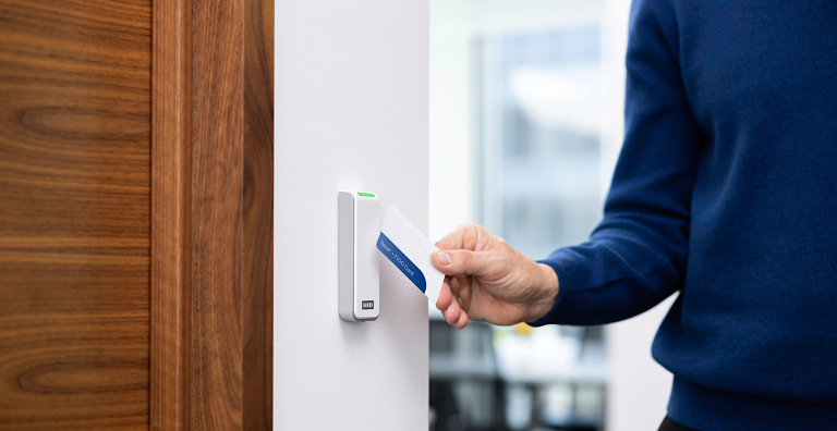 person unlocking door with smart card