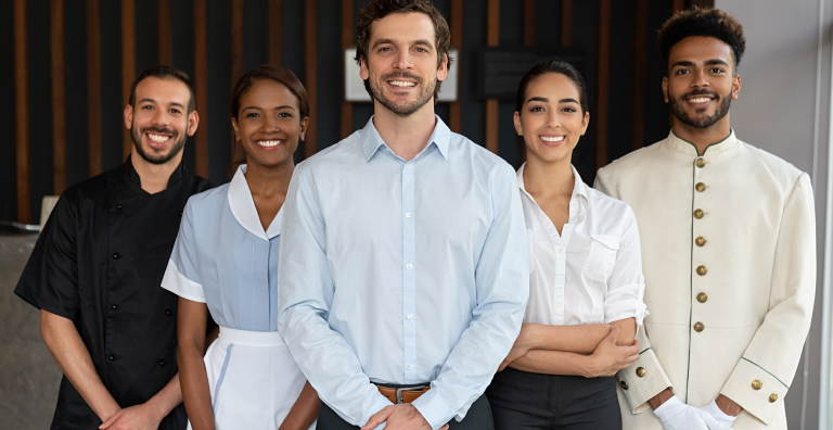 Hospitality staff standing together in uniforms, representing how RFID technology streamlines casino uniform tracking, laundry management and inventory contro
